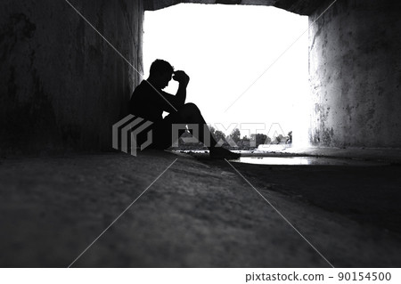 Silhouetted of sad photo. Lonely man sitting on the floor.He is unhappy and sad.He is depression.unlove,unhappy,fail.Photo concept for Disease and depression. Silhouetted of sad photo. Lonely man sitting on the floor.He is unhappy and sad.He is depression.unlove,unhappy,fail.Photo concept for Disease and depression. 90154500