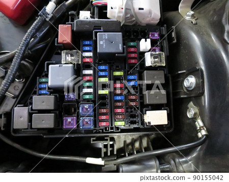 Fuse box containing various fuses in the hood of a car 90155042