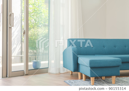 Blue sofa by the window 90155314
