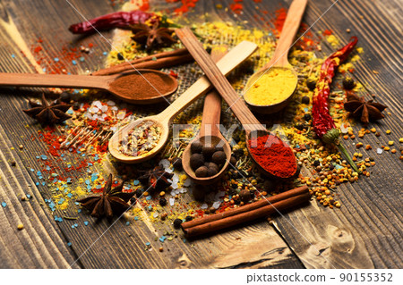 Wood spoons with pepper balls, paprika, curry and dry spices Wood spoons with pepper balls, paprika, curry and dry spices 90155352