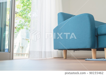 Blue sofa and wind swaying curtains 90155462