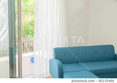 Blue sofa and wind swaying curtains 90155466