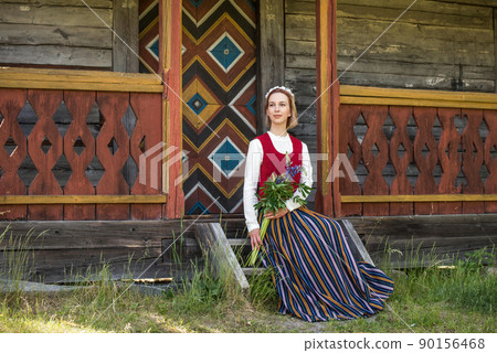 Latvian woman in traditional clothing. Ligo folk. Latvian woman in traditional clothing. Ligo folk. 90156468