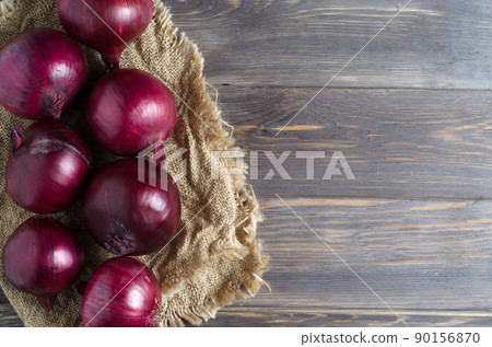 Red onions on old crumpled burlap. Copy space Red onions on old crumpled burlap. Copy space 90156870