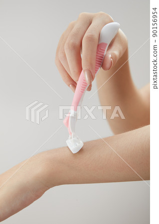 Front view of holding cosmetic roller on hand in white background for cosmetic advertising Front view of holding cosmetic roller on hand in white background for cosmetic advertising 90156954
