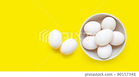 White eggs on yellow background. White eggs on yellow background. 90157348