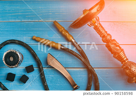 Parts of the hookah on blue wooden background. Hookah accessorie 90158598