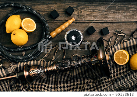 Dismantled parts of hookah on a wooden background with lemon fru Dismantled parts of hookah on a wooden background with lemon fru 90158618