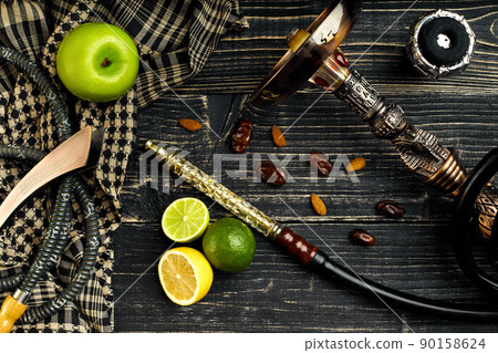 Dismantled parts of hookah on a wooden background with lime and 90158624