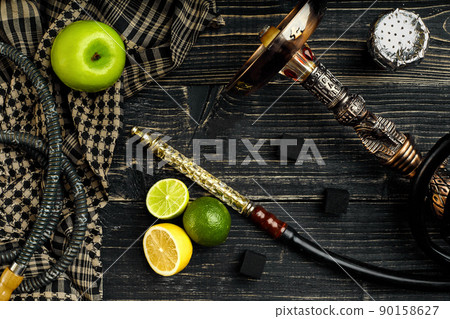 Dismantled parts of hookah on a wooden background with lime and Dismantled parts of hookah on a wooden background with lime and 90158627
