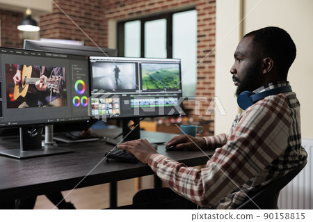 Digital footage professional editor at multi monitor workstation improving visual quality of content. Video editing expert sitting at desk in office workspace while digitally improving graphic project Digital footage professional editor at multi monitor workstation improving visual quality of content. Video editing expert sitting at desk in office workspace while digitally improving graphic project 90158815
