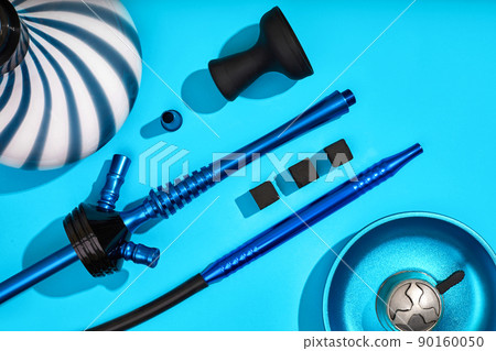 Parts of blue decorated hookah or shisha on light blue backgroun 90160050