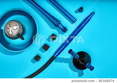 Parts of blue decorated hookah or shisha on light blue backgroun 90160074