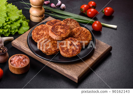 Meatballs with tomato sauce and herbs on the black plate 90162143