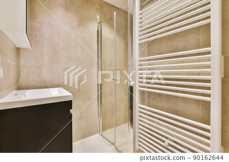 The luxury bathroom with brown tiled wall and floor 90162644