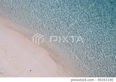 White sand beach and emerald green sea 90163190