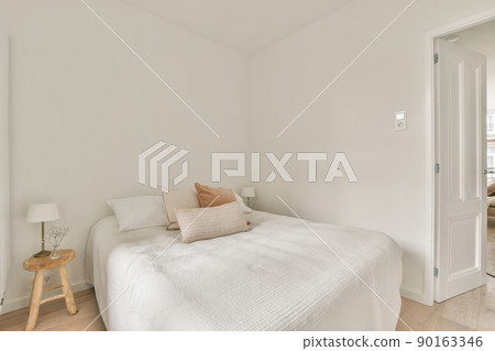 Home interior design of bedroom with bed and wooden wardrobe placed in corner near window in modern apartment Home interior design of bedroom with bed and wooden wardrobe placed in corner near window in modern apartment 90163346