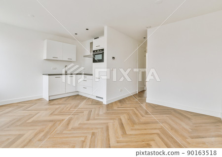 Corner of modern kitchen with white walls, wooden floor and white cabinets Corner of modern kitchen with white walls, wooden floor and white cabinets 90163518