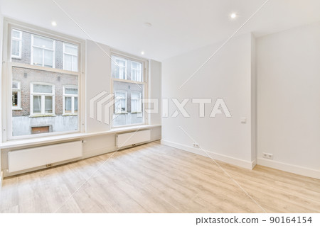 Plastic window and radiator on white wall in empty light room at home Plastic window and radiator on white wall in empty light room at home 90164154