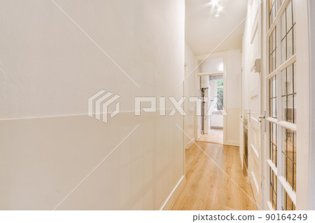 Light narrow hallway with many doors in white walls and glowing lamp over lumber floor Light narrow hallway with many doors in white walls and glowing lamp over lumber floor 90164249