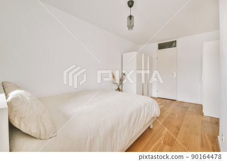 Home interior design of bedroom with bed and wooden wardrobe placed in corner near window in modern apartment Home interior design of bedroom with bed and wooden wardrobe placed in corner near window in modern apartment 90164478
