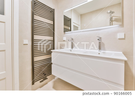 Bathroom with a double ceramic sink under a large mirror in a modern and cozy house Bathroom with a double ceramic sink under a large mirror in a modern and cozy house 90166005