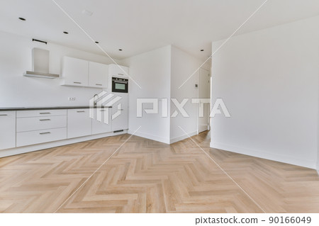 Interior of empty white kitchen with corridor and wooden parquet floor 90166049