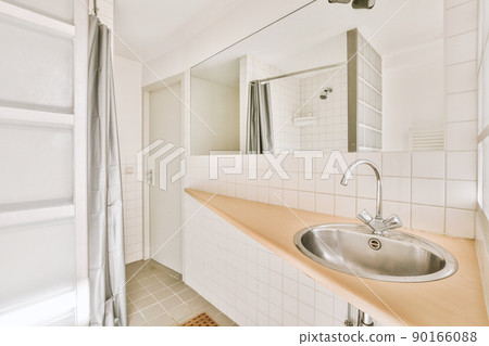 Bathroom interior surrounded by tiles in a modern house 90166088