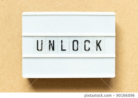 Lightbox with word unlock on wood background Lightbox with word unlock on wood background 90166896