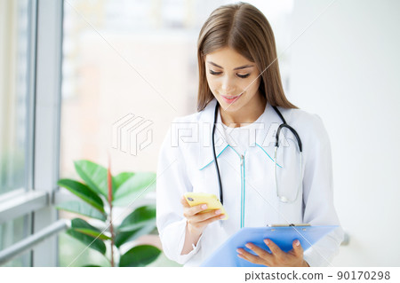 Medical beautiful female doctor in white coat with stethoscope. Medical beautiful female doctor in white coat with stethoscope. 90170298