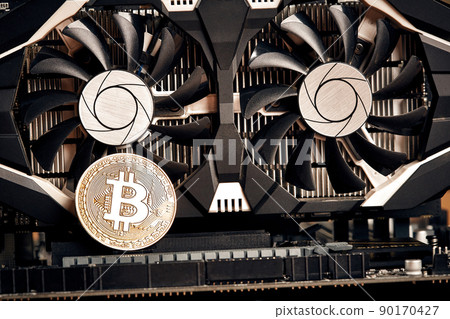 Bitcoin. New virtual money. Bitcoins lie on the video card, concept of mining. 90170427