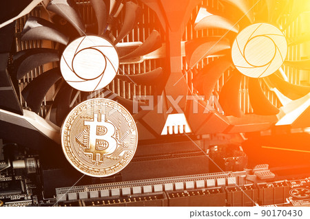 Bitcoin. New virtual money. Bitcoins lie on the video card, concept of mining. Sun flare 90170430
