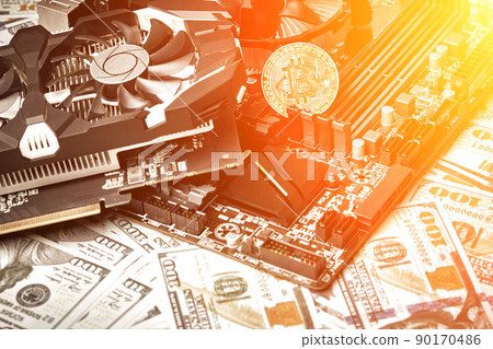 The coin of bitcoin lies on video card with dollars. Exchange bitcoin cash for a dollar. Sun flare The coin of bitcoin lies on video card with dollars. Exchange bitcoin cash for a dollar. Sun flare 90170486