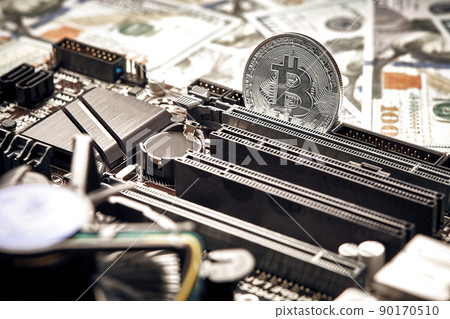The coin of bitcoin lies on video card with dollars. Exchange bitcoin cash for a dollar The coin of bitcoin lies on video card with dollars. Exchange bitcoin cash for a dollar 90170510