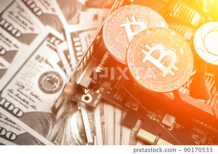 The coin of bitcoin lies on video card with dollars. Exchange bitcoin cash for a dollar. Sun flare The coin of bitcoin lies on video card with dollars. Exchange bitcoin cash for a dollar. Sun flare 90170533