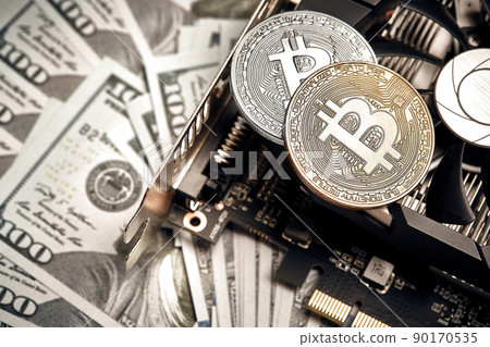The coin of bitcoin lies on video card with dollars. Exchange bitcoin cash for a dollar The coin of bitcoin lies on video card with dollars. Exchange bitcoin cash for a dollar 90170535