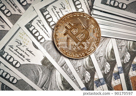 A symbolic coins of bitcoin on banknotes of one hundred dollars. Exchange bitcoin cash for a dollar. A symbolic coins of bitcoin on banknotes of one hundred dollars. Exchange bitcoin cash for a dollar. 90170597