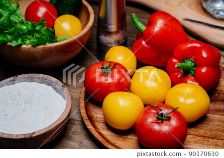 a wooden bowl of flour, spices and vegetables on the kitchen table a wooden bowl of flour, spices and vegetables on the kitchen table 90170630