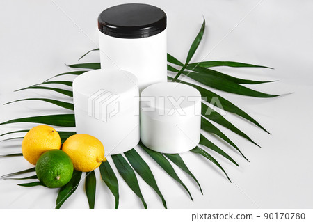 White bottles and two whole lemon and lime isolated on white background. The concept for advertising cosmetics White bottles and two whole lemon and lime isolated on white background. The concept for advertising cosmetics 90170780