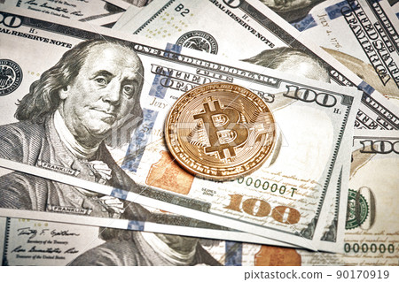 A symbolic coins of bitcoin on banknotes of one hundred dollars. Exchange bitcoin cash for a dollar. A symbolic coins of bitcoin on banknotes of one hundred dollars. Exchange bitcoin cash for a dollar. 90170919