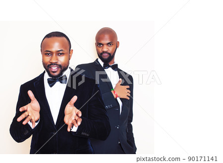 two african-american businessmen in black suits emotional posing, gesturing, smiling. wearing bow-ties close up two african-american businessmen in black suits emotional posing, gesturing, smiling. wearing bow-ties close up 90171141