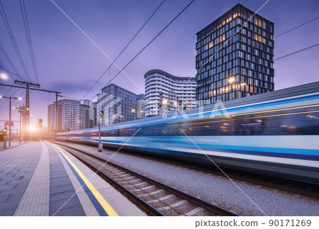 High speed train in motion on the railway station at sunset 90171269