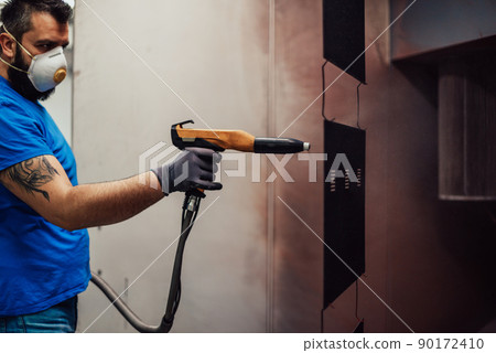 The painter paints the iron element. Industrial painting parts. Metal designs  90172410