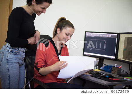 Within the heavy industry, a factory industrial engineer measures with a caliper and on a personal computer Designs a 3D model 90172479