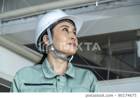 Female air conditioning equipment engineer checking the site 90174675