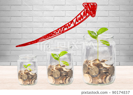 Coins in a glass jar with upwardly growing seedlings Coins in a glass jar with upwardly growing seedlings 90174837