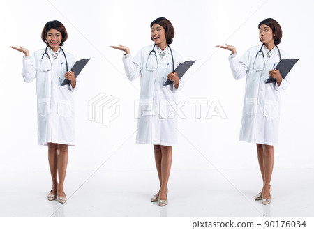 Full length 20s young Asian Doctor Woman wear stethoscope; uniform coat, show empty palm hand. Full length 20s young Asian Doctor Woman wear stethoscope; uniform coat, show empty palm hand. 90176034