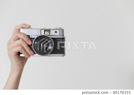 Hand holding a camera photo material 90176355