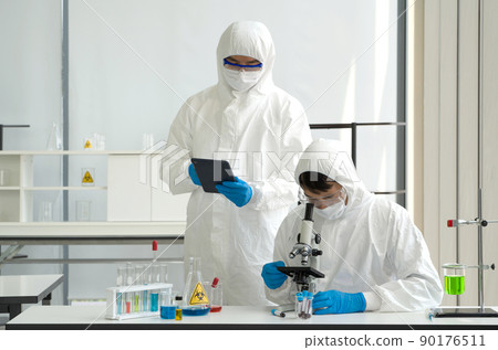 Epidemiological researcher in virus protective cloth working in laboratory. Omicron strain testing process, Coronavirus disease 2019. 90176511