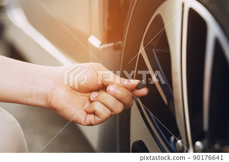 close up hand man car parking a check and inflate the tire fill up the air for safe driving on the go. Transportation travel vehicle concept. 90176641